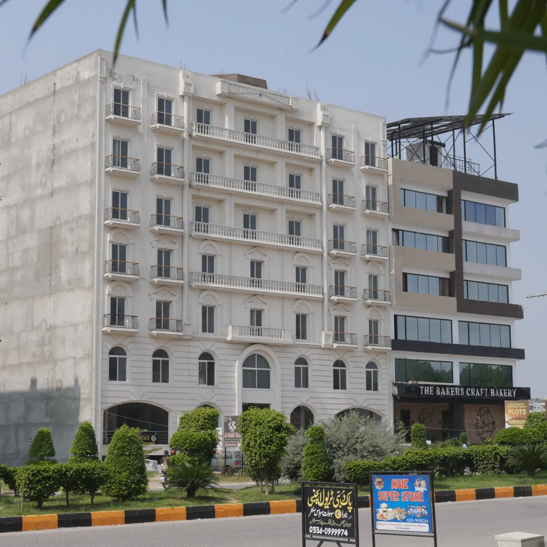 A block of flats beside a landscaped road
