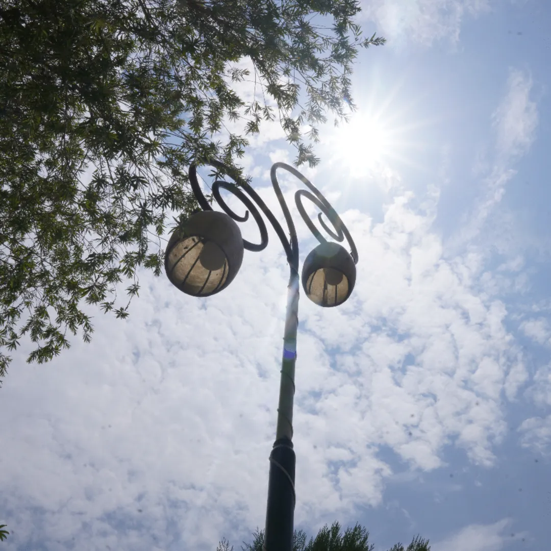 A decorated street light against the sky